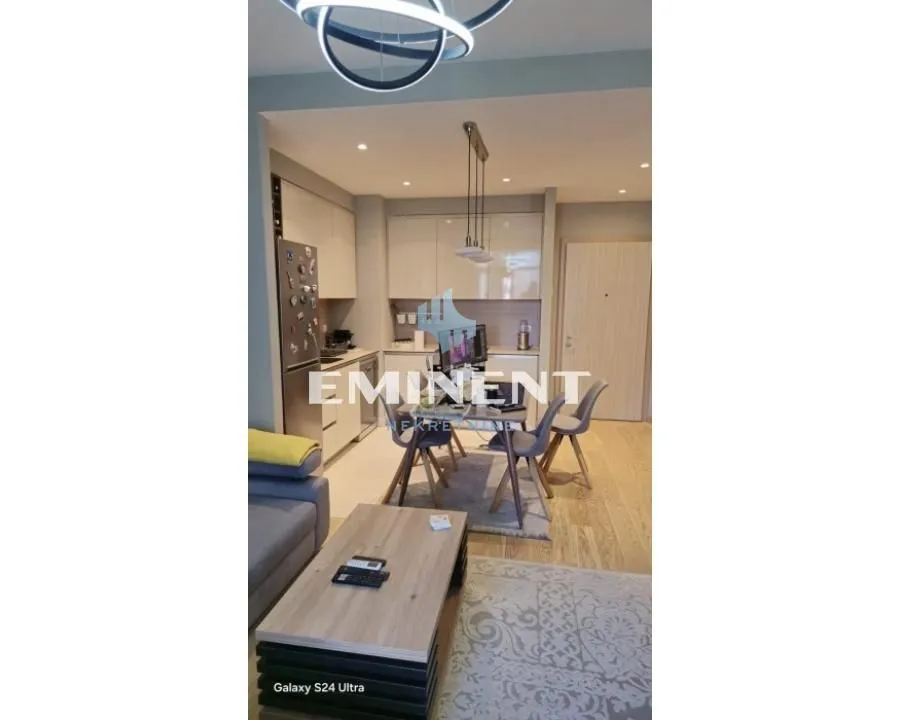 Open-plan living room with dining area and kitchen.