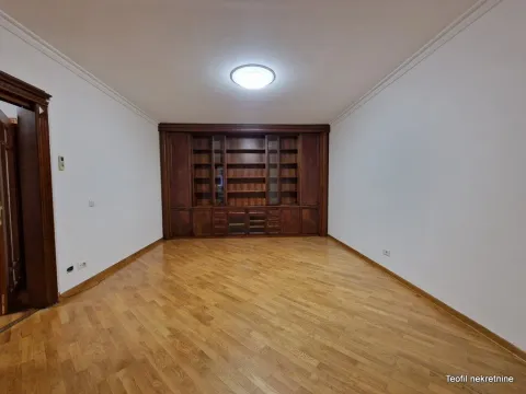 Empty living room with a wooden display cabinet and hardwood flooring. - image 7
