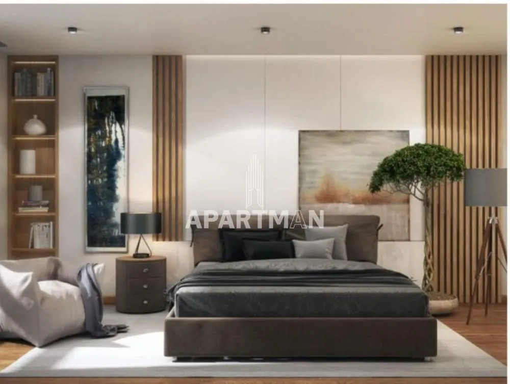 Modernly decorated bedroom with a large double bed and decorative wall panels.