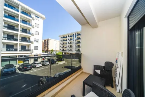 Furnished balcony with outdoor seating and a view of the street and buildings. - image 10