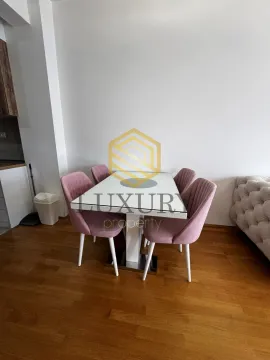 Dining area with a table and pink chairs. - image 8