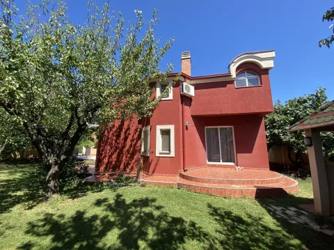 Facade of a red house with a landscaped yard and green lawn. - image 7