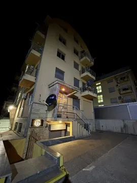 Night view of the exterior of the residential building with entrance and balconies. - image 10