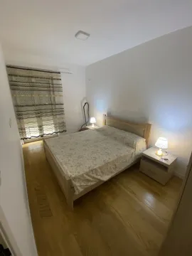 Simply furnished bedroom with a double bed and nightstands. - image 7