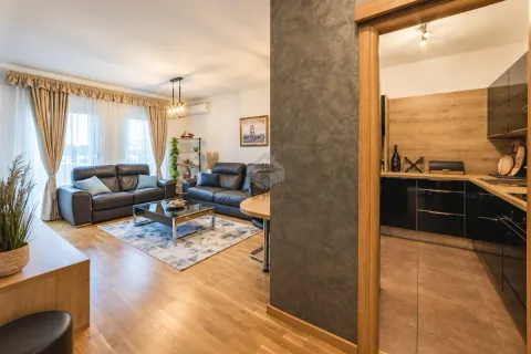 Living room with a sofa set and a view of the kitchen. - image 13