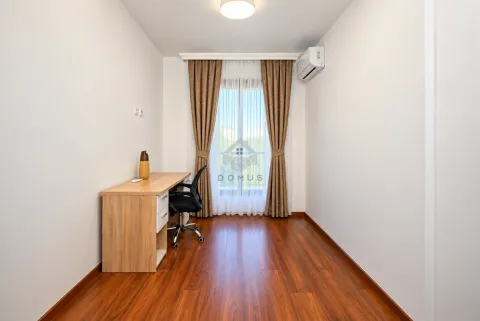 Small room with a desk and chair, hardwood flooring, and a window with curtains. - image 24