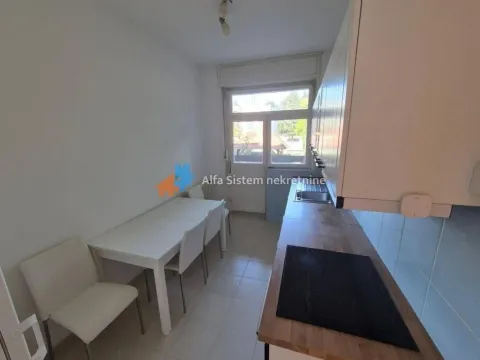 Small kitchen with a dining table and access to the terrace. - image 7