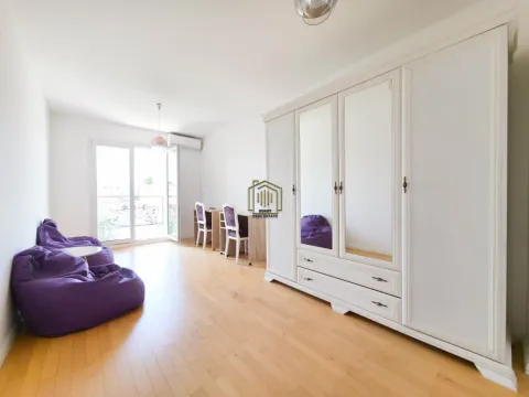 Spacious bedroom with a large white wardrobe and purple bean bags. - image 11