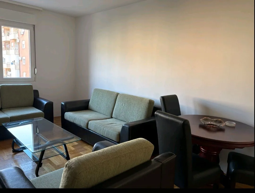 Living room with a sofa set, coffee table, and dining area.