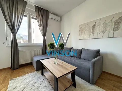 Living room with a grey sofa, coffee table and window. - image 3