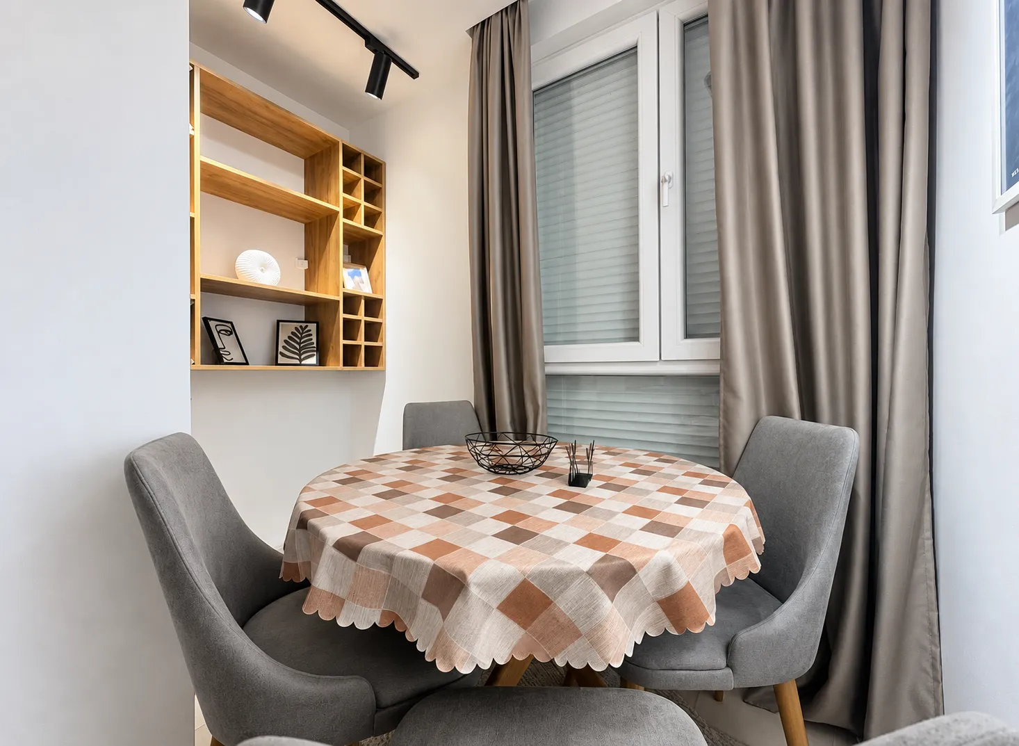Dining area with a table, chairs, and built-in wall shelves.