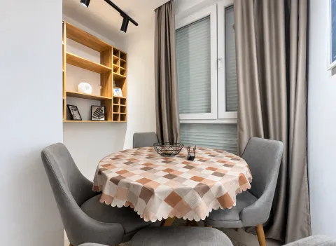 Dining area with a table, chairs, and built-in wall shelves. - image 7