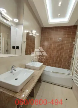 Modern bathroom with double sinks, a bathtub and a large mirror. - image 14
