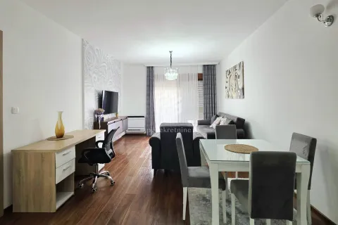 Spacious living room with a dining area and a desk. - image 18