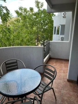 Furnished balcony with a table and chairs and a green view. - image 15