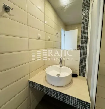 Small bathroom with a washbasin and ceramic tiles. - image 8