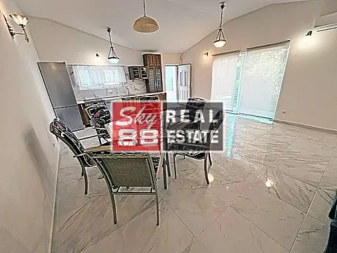 Spacious living room with dining area and kitchen in the background. - image 6
