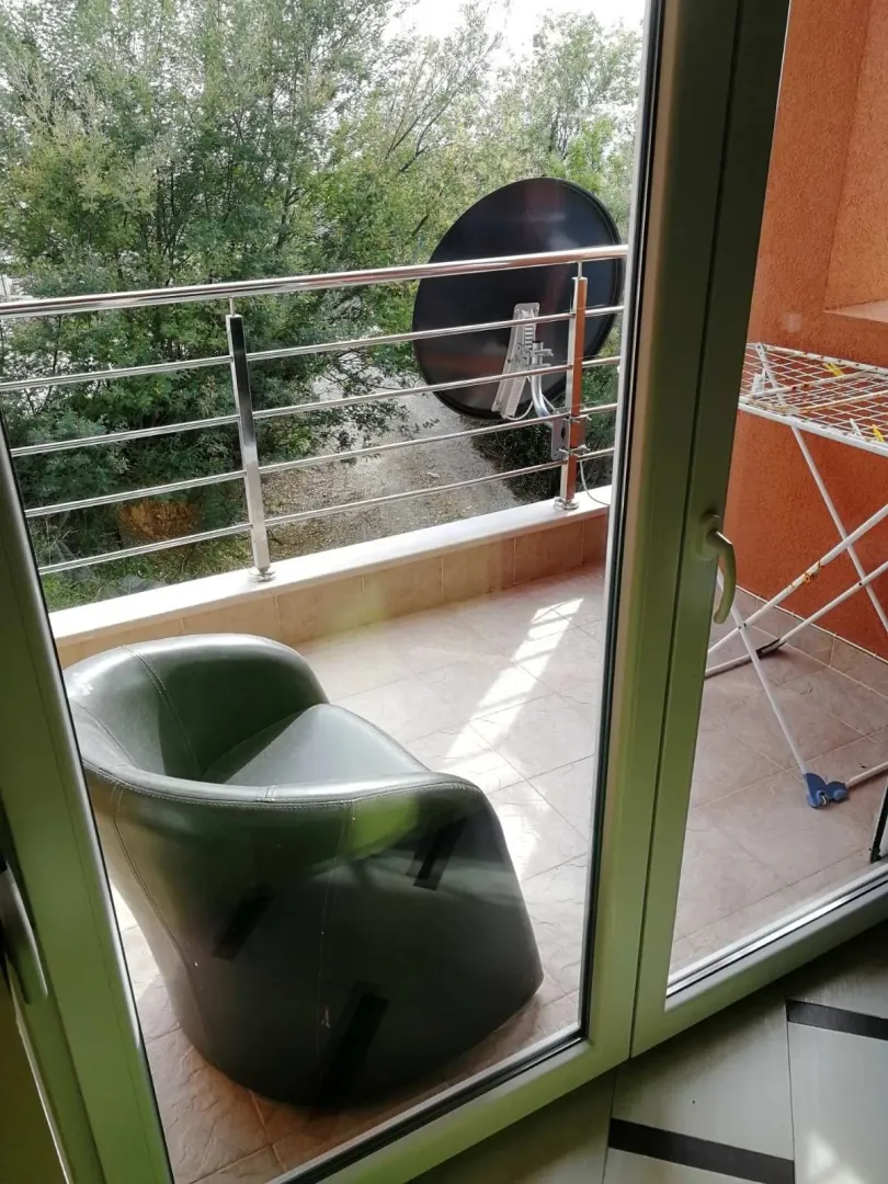View of the balcony with an armchair and a drying rack.