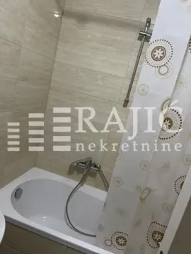 Small bathroom with a bathtub and shower curtain. - image 14