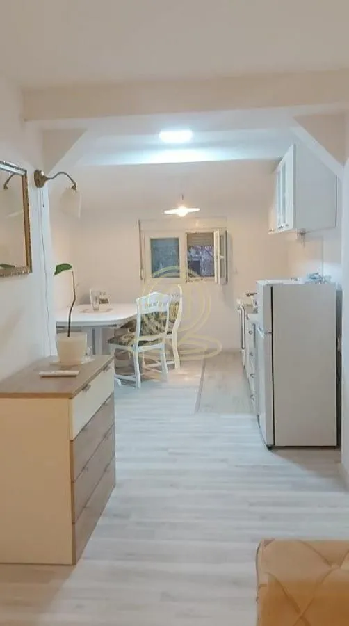 Small kitchen with a dining area and white goods.