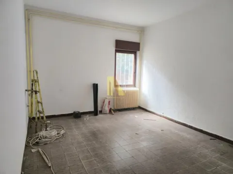 Empty room with a window, tiled floor, and construction supplies. - image 4
