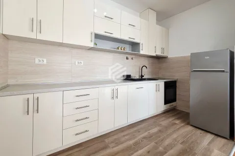 Kitchen equipped with white cabinets, built-in appliances, and a refrigerator. - image 7