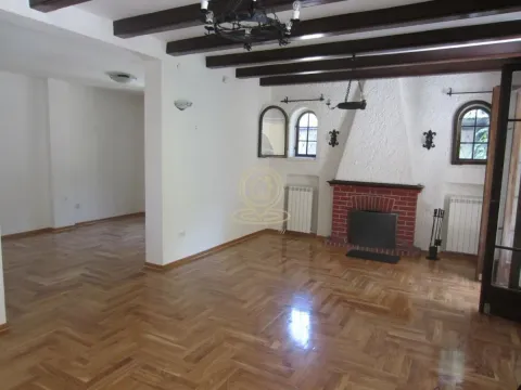 Living room with a fireplace and exposed wooden ceiling beams. - image 6