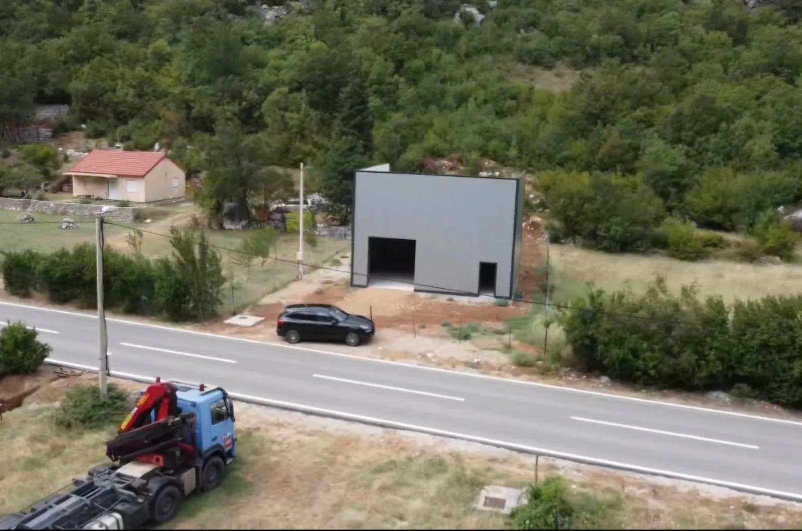 Aerial view of a newer commercial building by the road.