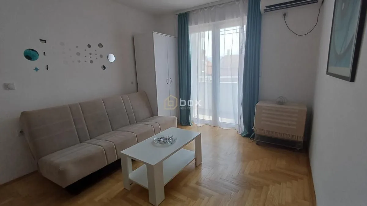 Living room with a sofa set, coffee table, and wardrobe.