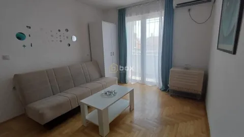 Living room with a sofa set, coffee table, and wardrobe. - image 2