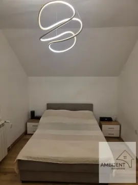 Furnished bedroom with a double bed and a modern chandelier. - image 9