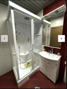 Bathroom equipped with a hydromassage shower cabin and a vanity unit with a washbasin. - image 2