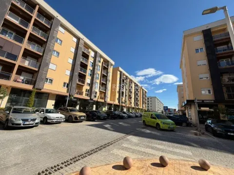 Exterior of residential buildings with a paved courtyard and parked cars. - image 13