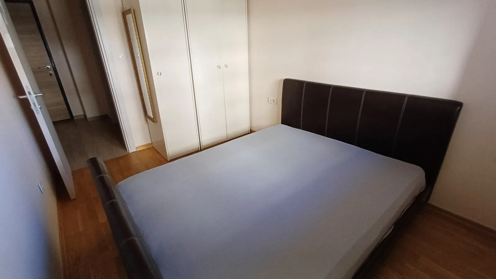 Bedroom with a double bed and a fitted wardrobe.