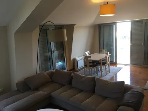 Spacious living room with a sofa set and dining area in the attic. - image 3