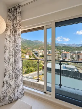 View of the city and mountains from the balcony. - image 2