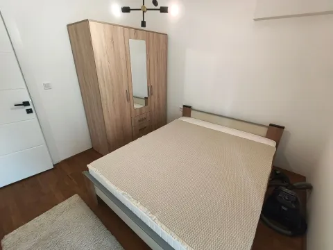 Bedroom with a double bed and a wooden wardrobe. - image 7