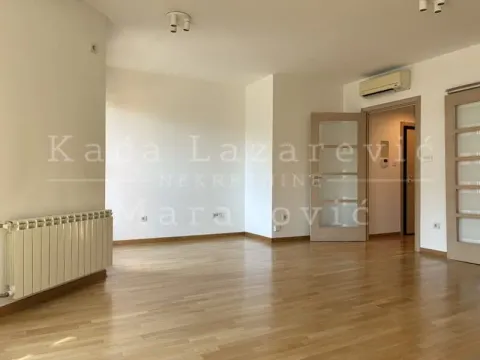 Empty living room with wooden flooring, radiator, and air conditioning. - image 5