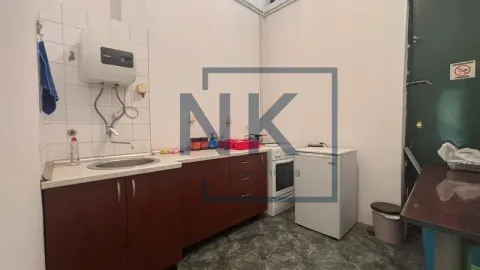 Small kitchen with a sink, cabinetry, and kitchen appliances. - image 12