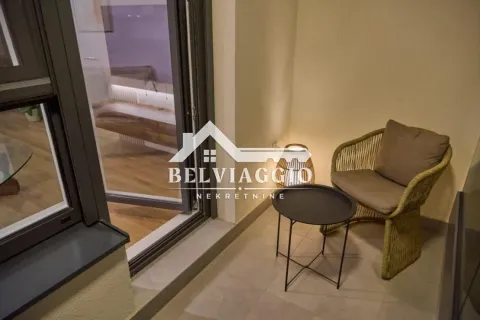 Small furnished balcony with an armchair and a small table. - image 21