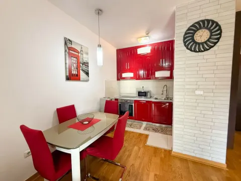 Kitchen with a dining area and red cabinetry. - image 2