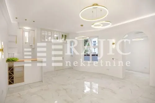 Bright and spacious living room with modern lighting.
