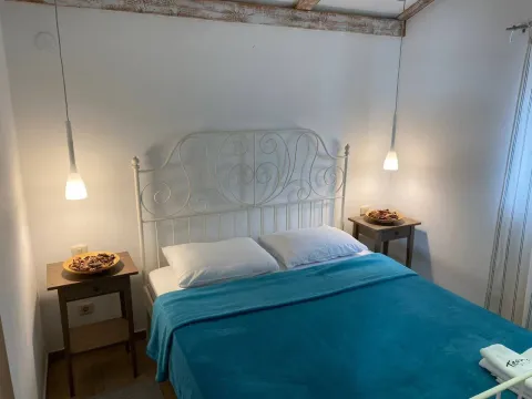 Furnished bedroom with a double bed and nightstands. - image 3