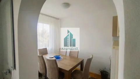 Dining room with a wooden table and chairs, viewed through an arched doorway. - image 4