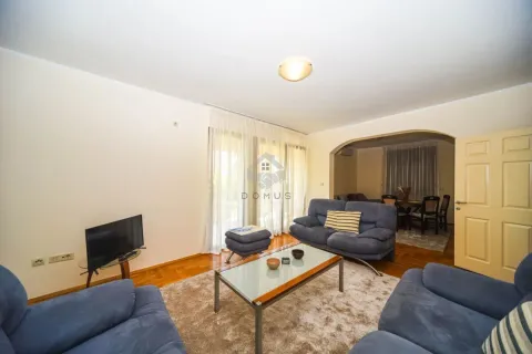 Living room with sofa set, coffee table and TV, with a view of the dining area. - image 3
