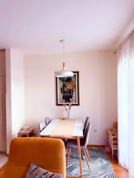 Dining area with a table, chairs, and decorative details. - image 2