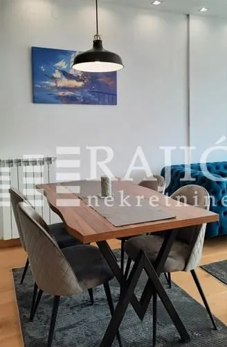 Dining area with a wooden table and modern chairs.