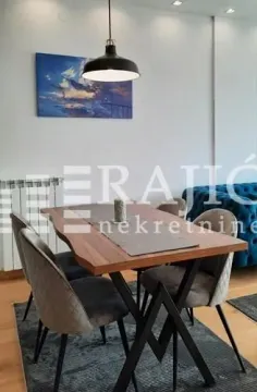 Dining area with a wooden table and modern chairs. - image 4