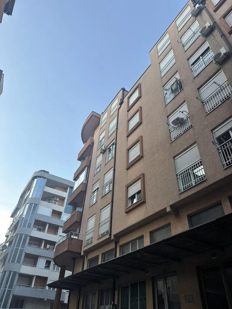 View of the exterior of an apartment building with balconies and windows.