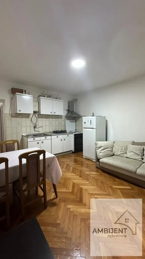 Small kitchen with a dining table and a sofa.